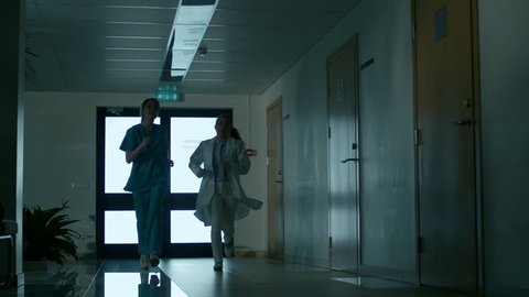Emergency in the Hospital, Doctors and Nurses Running through the Hallway, in a Hurry to Save Lives. Shot on RED EPIC-W 8K Helium Cinema Camera.