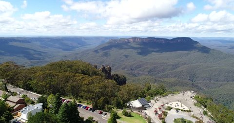 People watching Three sisters rock formation in Blue Mountains national park from Katoomba town in aerial panning.
