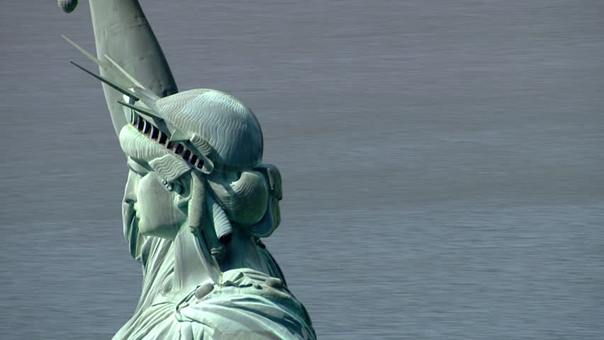 Aerial close up Statue of Liberty face on beautiful summer day celebrating July 4th independence holiday. Symbol of freedom in USA.