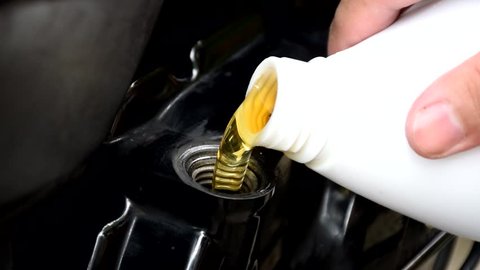 Change engine oil of your Motorcycle. - Engine Oil Change. , Pouring oil to Motorcycle engine.