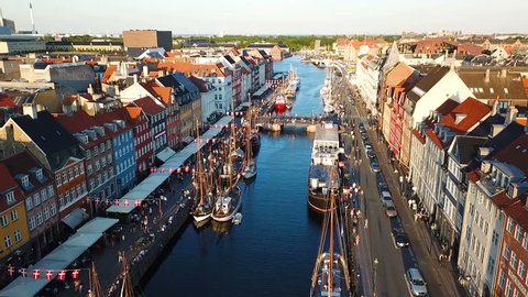 sunset footage video from Copenhagen, Denmark. Nyhavn New Harbour canal and entertainment district. Aerial Video footage view from the top. the camera rotates in a circle. Sunset golden time light.