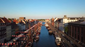 amazing busy old street in Copenhagen, Denmark. bridge in Nyhavn New Harbour canal and entertainment district. Aerial Video footage view from the top.