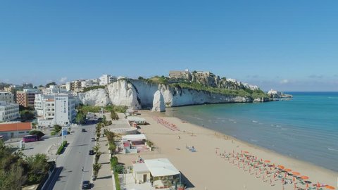 White rock and beach Polignano a Mare Apulia City Sea Coastline white houses and castle in Italy Drone flight
