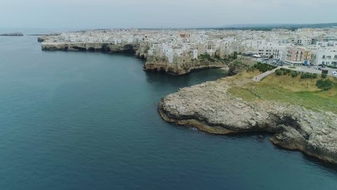 City Sea Coastline and white houses Polignano a Mare Apulia in Italy Drone 4k