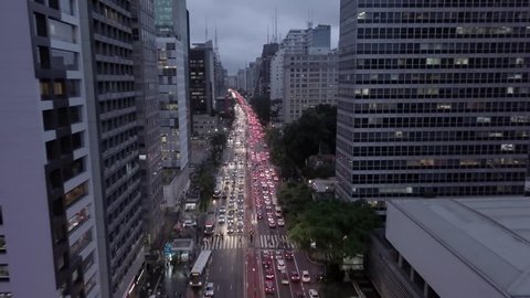 4K UHD Dolly Travelling "Zoom" Out Aerial Shot of Avenue Between Buildings - Avenida Paulista, São Paulo, Brazil During Rush Hour