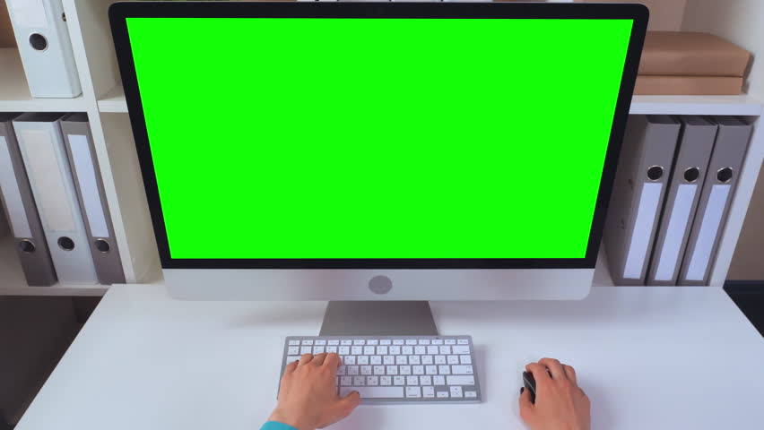 woman sitting at the working place desktop with green screen. worker using pc mouse and keyboard playing game Royalty-Free Stock Footage #1012090562