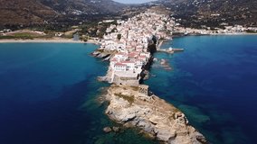 Aerial drone bird's eye view video of iconic and picturesque Andros island chora, Cyclades, Greece