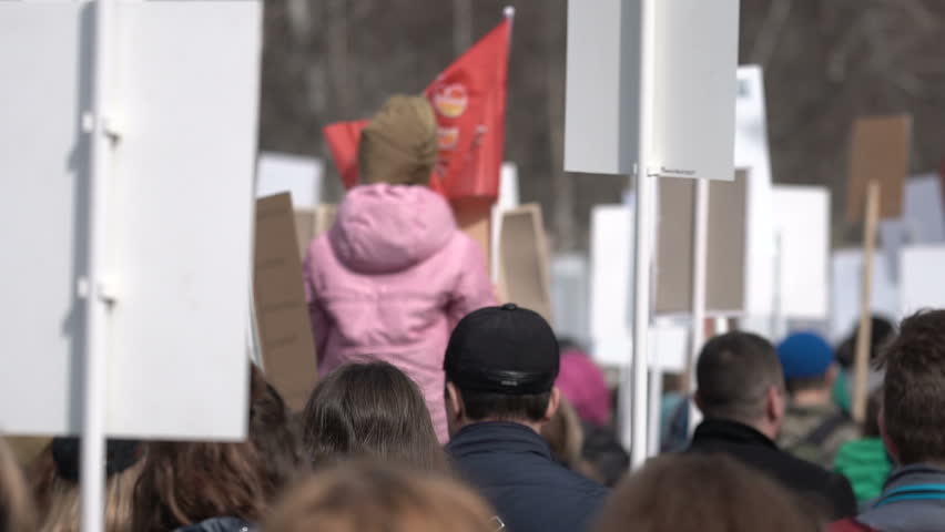 A meeting of anger people with signs and transports closeup. Many people go and defend their interests. People do not agree and protest close up. Political strike 2019 4k. Angry crowd strike. Royalty-Free Stock Footage #1012094579