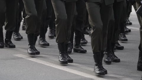 A close-up of the feet of military men who march on the parade on May 9, 2018 in a slow motion shot. Same clothes and shoes in public. Military march close-up in slowmotion shooting.
