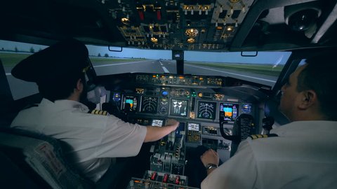 Professional pilot is giving instructions to an amateur while taking off in a flight simulator