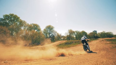 Motorcycler is performing a jumping trick on his sportbike