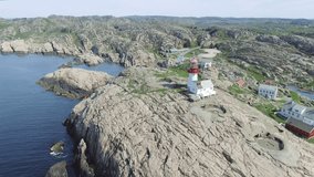 Video of Lindesnes beacon in summer, South Norway. Aerial shot. Rocky sea coast and blue sky.