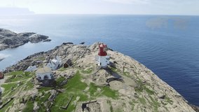 Video of Lindesnes beacon in summer, South Norway. Aerial shot. Rocky sea coast and blue sky.