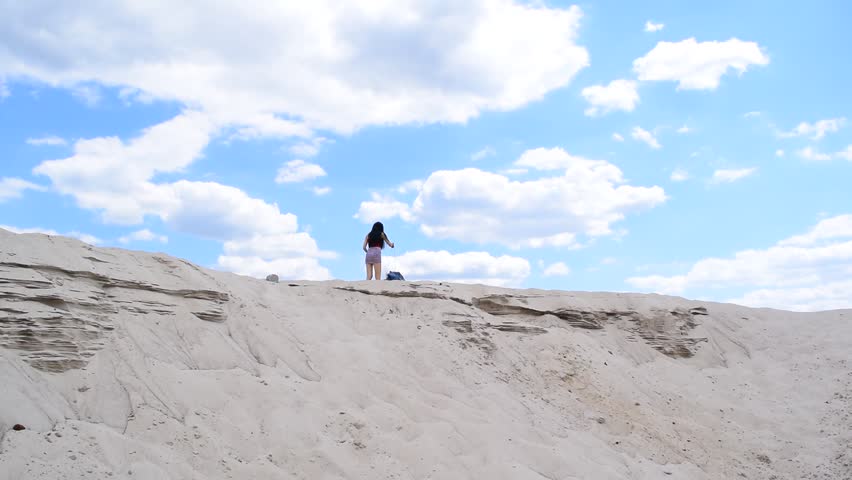 Brunette girl walking in the desert. Bottom view
