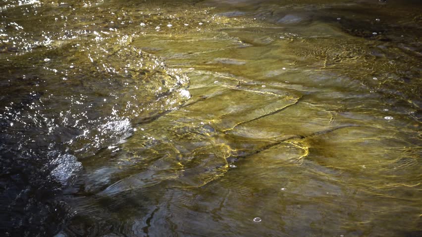Flowing water, reflection, background. A small river, originating from a waterfall. Blue Hen Falls, Cuyahoga Valley National Park. Ohio USA