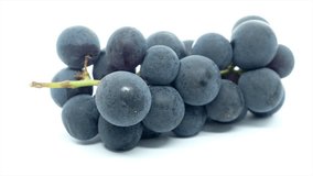 Black grapes over white background.