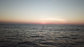 Surfing and Stand Up Paddle (SUP) at sunset