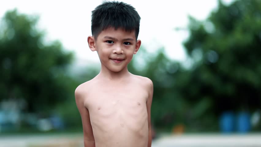 Little Asian boy shows his muscles outdoors. little boy winner sign Royalty-Free Stock Footage #1012125254