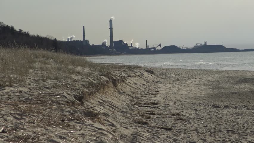 Plant with smoking pipes on the shore of the lake, pollution of the environment, ecology. Indiana Dunes National Lakeshore 