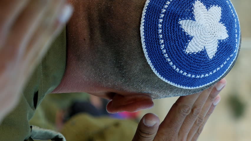 Israeli soldier military man saluting to the Western wall in Jerusalem. Western wall or Wailing wall or Kotel in Israel is the most sacred place for all jewish people. Vertical format video.