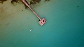 Aerial of double kayak paddling on sea and tourist relaxing on wooden pier at Koh Kood, Trat, Thailand, (video from drone)