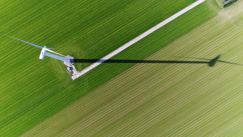 Aerial top down view of wind turbine a device that converts the wind's kinetic energy into electrical energy providing renewable energy sustainable energy into the electricity grid 4k high resolution Royalty-Free Stock Footage #1012139831