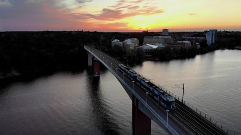 Aerial footage of the tramway bridge Alviksbron in Stockholm at sunset.
