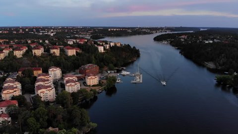 Aerial footage of the Stockholm island Stora Essingen and its western shore at dusk
