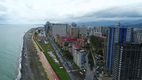 Aerial view video of Batumi at rainy day. view on sea and seafront road during cloudy day. Aerial camera shot