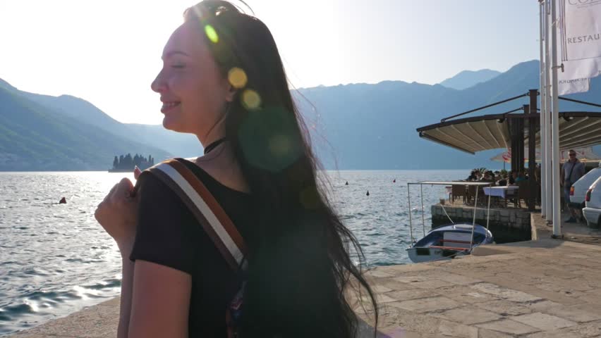 Women against the backdrop of mountains and the sea.