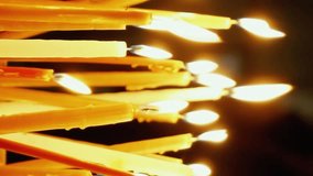 Burning candles. Celebration event or religious memorial attribute of warmth and sincerity. Vertical format video.