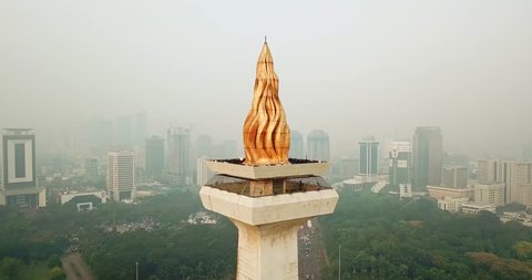 JAKARTA, Indonesia - June 08, 2018: Aerial scenery of Jakarta National Monument with fog of air pollution. Shot in 4k resolution from a drone