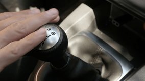 Hand touches manual gear shift stick in car 4K footage