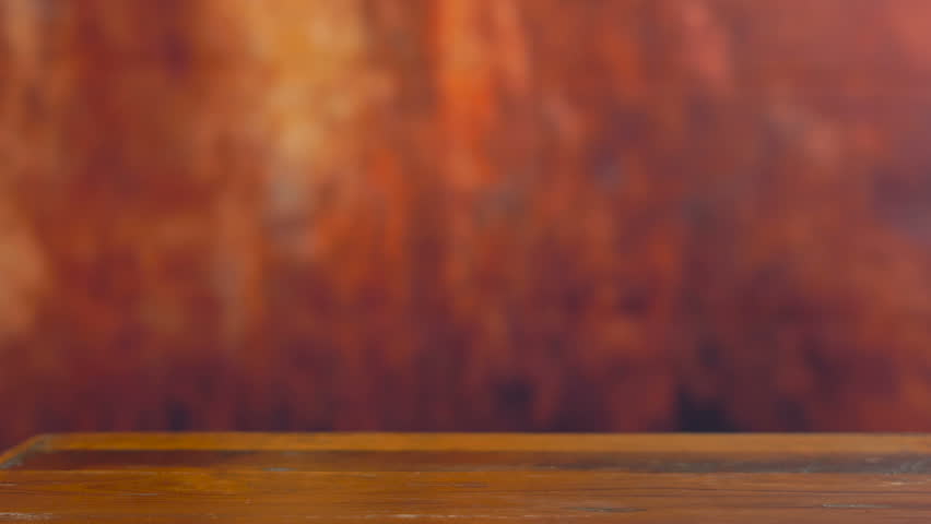 Happy Birthday purple theme cupcake with party gifts on dark wood background.