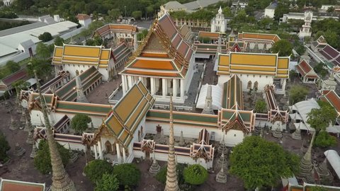 Beautiful Wat Phra Kaew temple and bangkok skyline in 4k drone view. Thai Buddhist temple Wat Pho main tourist attraction aerial shot.  Emerald Buddha