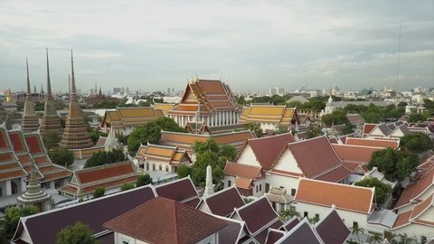 Thai Buddhist temple Wat Phra Kaew temple drone views in 4K. Aerial views of Thai Buddhist temple in Bangkok. bird's eye perspective from above. Skyline background