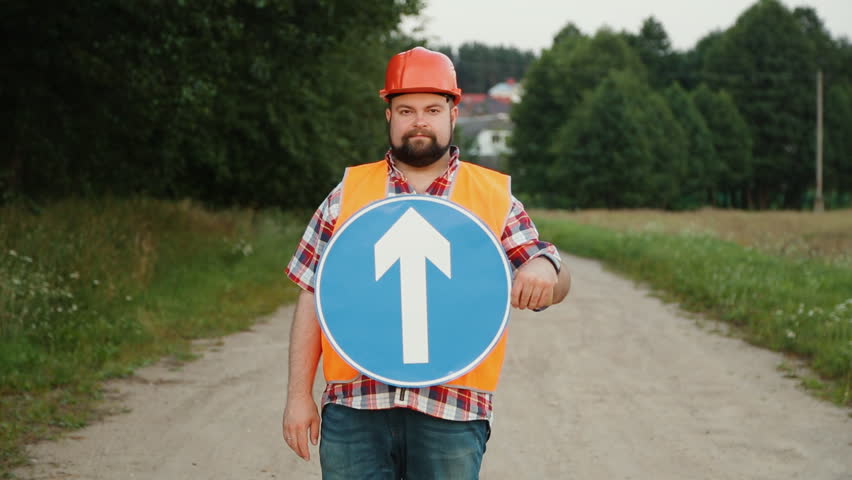 Construction worker showing Turning traffic signs up