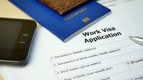 Work Visa application form with passport and pen. Document with passport, apply and permission for foreigner country