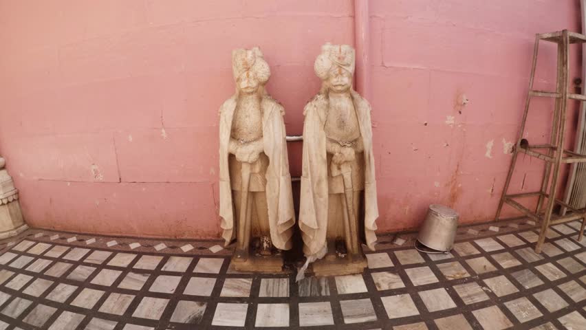 foreing girl feeds rats and mouses at foots of Rajastan warriors statues Karni Mata Temple