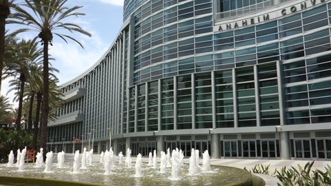Anaheim, CA / USA - May 30, 2018: A slow pan up from the fountain to the exterior of the Anaheim Convention Center on a sunny day