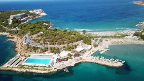 Aerial drone bird's eye video of famous celebrity area of Astir or Asteras in south Athens riviera Peninsula, Vouliagmeni, Greece