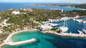 Aerial drone bird's eye video of famous celebrity area of Astir or Asteras in south Athens riviera Peninsula, Vouliagmeni, Greece