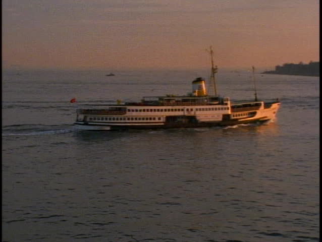 TURKEY, 1999, Ferry boat on bay, pan right, sunset, Istanbul