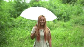 Woman walking hand holding white umbrella under rain 
