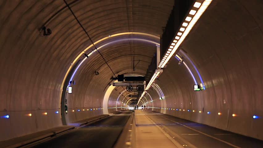 Cyclists, pedestrians and a runner in a modern tunnel. Lyon, France.