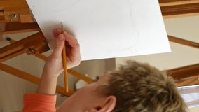 Female artist draws a pencil sketch drawing on canvas easel in art studio. Student girl learning to draw and paint. Vertical format video.