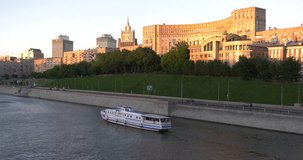 4K high quality spring evening sunset video footage of Moscow city skyline and panorama of buildings, boats sailing on the Moskva River and embankment near city center in the capital of Russia