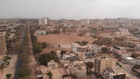 African city aerial with dirt football field: Dakar, Senegal.
