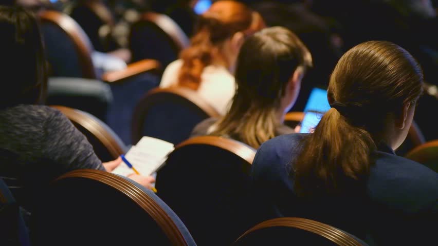 Audience listens to the lecturer at the conference hall