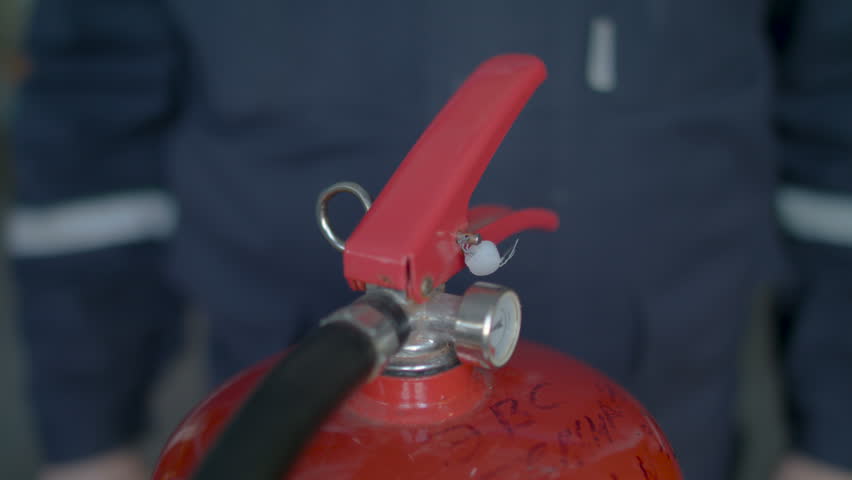 Instructor teaches the use of a fire extinguisher, close up Royalty-Free Stock Footage #1012213292